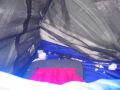 Snow has blown in through the mesh, covering me and soaking the sleeping bag (view toward my head)